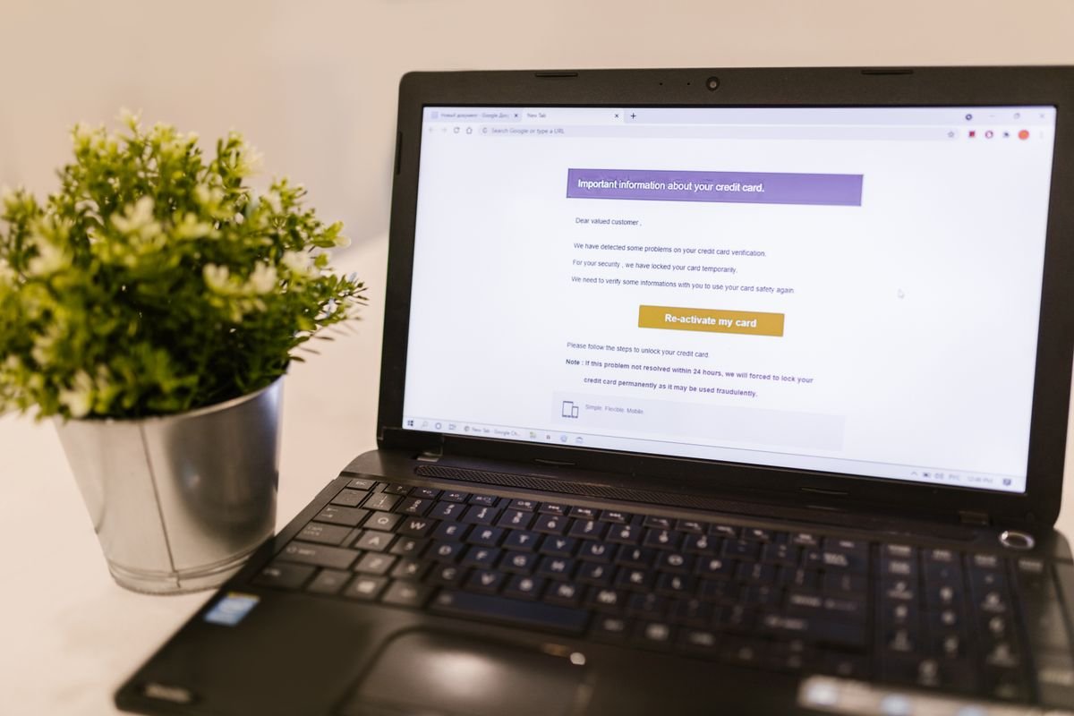 A laptop displaying a financial document on a desk in a well-lit office