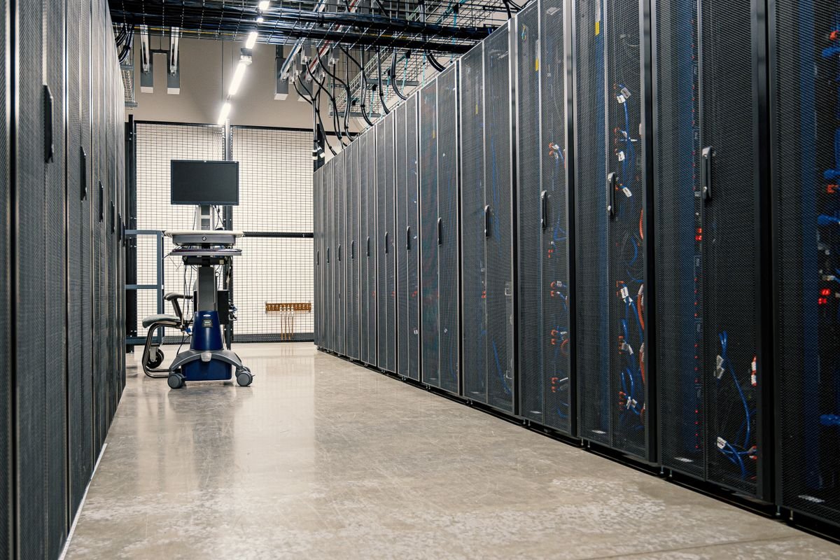 Steel-framed server cabinets with networking devices and cables in a data centre